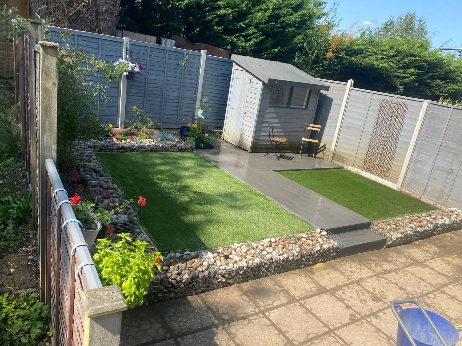 Finished landscaped garden with decking, lawn, and stone borders